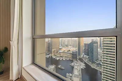 a view of a city from a window at Aesthetic Beach Apartment , Sleeps 6, Pool, Gym & Waterfront Views in Dubai