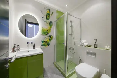 a bathroom with a shower and a toilet and a sink at Stellar 2BR on Palm Jumeirah - Beach and Pool access in Dubai