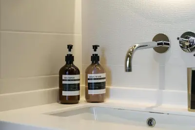 two bottles of soap sitting on top of a sink at Stellar 2BR on Palm Jumeirah - Beach and Pool access in Dubai