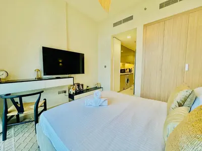 a hotel room with a bed and a tv at Venduras - Modern Chic Studio in Azizi Riviera in Dubai