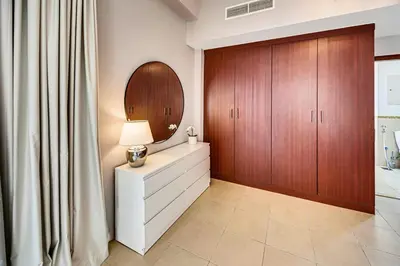 a living room with a dresser and a mirror at Luxury 2Bedroom with Stunning Sea View in JBR in Dubai
