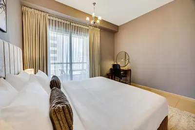 a bedroom with a large white bed and a window at Luxury 2Bedroom with Stunning Sea View in JBR in Dubai