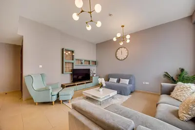 a living room with a couch and a tv at Luxury 2Bedroom with Stunning Sea View in JBR in Dubai