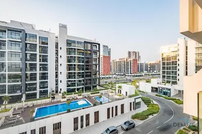 an aerial view of a building with a swimming pool at Charming 1BR Apartment in Azizi Riviera 30, Al Merkadh by Deluxe Holiday Homes in Dubai