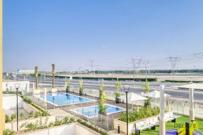 an overhead view of the pool at a resort at Charming 1BR Apartment in Azizi Riviera 30, Al Merkadh by Deluxe Holiday Homes in Dubai