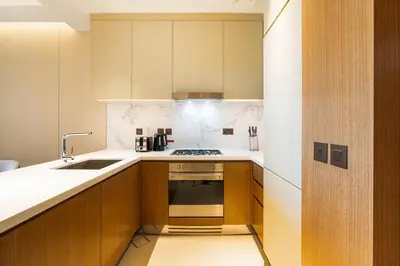 a small kitchen with a sink and a stove at Deluxe Address Opera Home with Full Sea View in Dubai