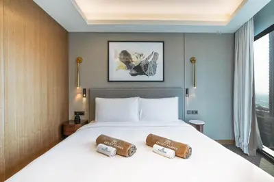 a bedroom with a bed with two pillows on it at Deluxe Address Opera Home with Full Sea View in Dubai