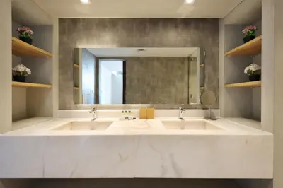a bathroom with two sinks and a large mirror at Livbnb - Contemporary Suite with Private Plunge Pool in Dubai