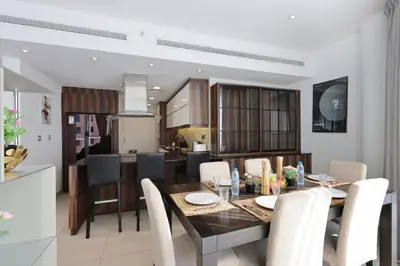 a dining room and kitchen with a table and chairs at Livbnb - Contemporary Suite with Private Plunge Pool in Dubai