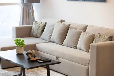 a living room with a couch and a coffee table at Luxurious 1BR in Court Tower Business Bay in Dubai