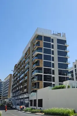 a large apartment building in the middle of a street at HAVN - 1 Bedroom Unit in Azizi Riviera, Meydan in Dubai