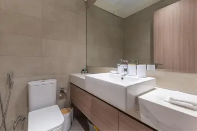 a bathroom with a white sink and a toilet at HAVN - 1 Bedroom Apartment in Azizi Riviera in Dubai