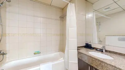 a bathroom with a tub and a sink at Bay Central - One Bedroom with Marina View in Dubai