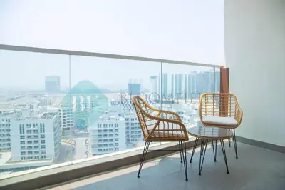 two chairs and a table on a balcony with a view at Bloomfields Hidden Gem Studio In Arjan in Dubai