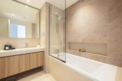 a bathroom with a tub and a sink and a shower at Stunning Two-Bedroom Apartment with Skyline View & walk to Dubai Mall by TerraHome in Dubai