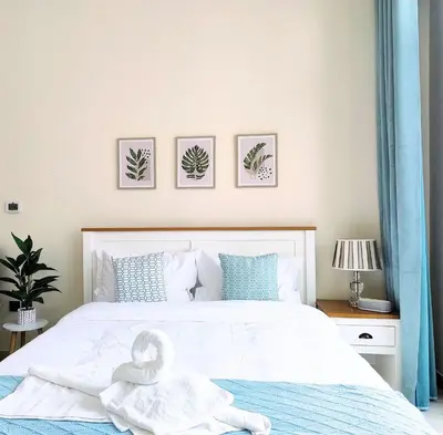 a bedroom with a bed with a swan on it at Farhad Azizi Residence - Al Jaddaf by Golden Casa in Dubai