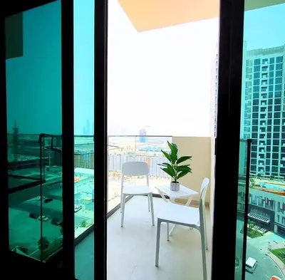 a balcony with a table and chairs on a building at Farhad Azizi Residence - Al Jaddaf by Golden Casa in Dubai