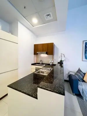 a kitchen with a counter top in a room at Beautiful studio apartment in Dubai