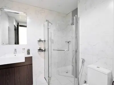 a bathroom with a shower and a toilet and a sink at StoneTree - Fully Furnished - Dania 2 in Dubai
