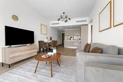 a living room with a couch and a tv at StoneTree - Newly Furnished - Al Furjan in Dubai