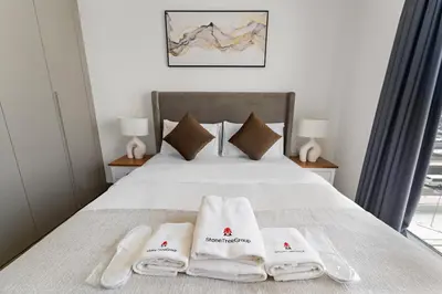 a bedroom with a bed with towels on it at StoneTree - Newly Furnished - Al Furjan in Dubai
