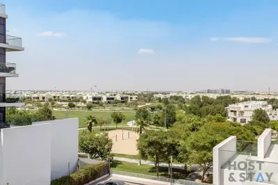 a view of a park from a building at Calm and Cozy Studio in Loreto 1A, Damac Hills in Dubai