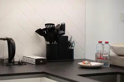 a counter top with a container of kitchen utensils at Sophisticated 1BR with Pool View in Belgravia Square JVC in Dubai