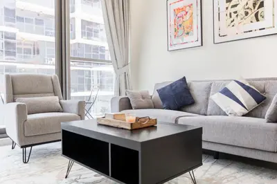 a living room with a couch and a coffee table at Serenity Living - stunning 1BR, DAMAC Hills in Dubai