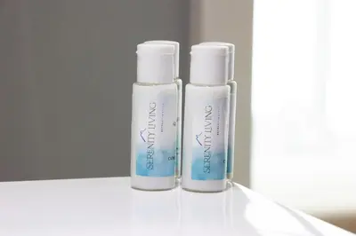 two bottles ofodorizers sitting on a white table at Serenity Living - stunning 1BR, DAMAC Hills in Dubai