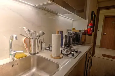a kitchen counter top with a sink and a counter top at Chic and Cozy Studio in Dubai