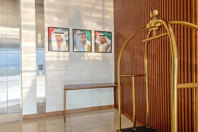 a room with pictures of men on a wall at Chic and Cozy Studio in Dubai