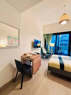 a bedroom with a desk and a bed and a chair at Heavenly Adobe in Dubai