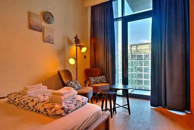a hotel room with a bed and a window at Paradise Point in Dubai