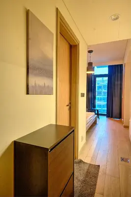 a living room with a table and a bedroom at Paradise Point in Dubai