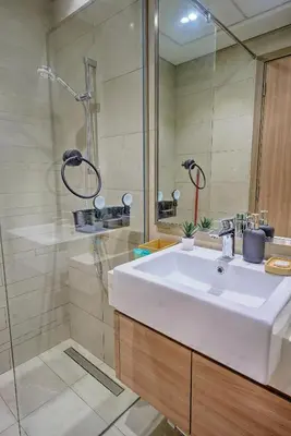 a bathroom with a white sink and a shower at Paradise Point in Dubai