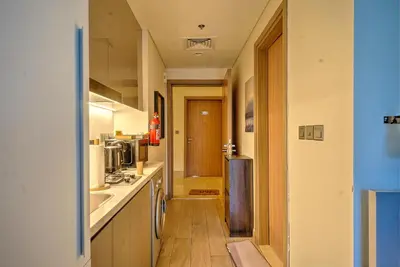 a kitchen with a sink and a refrigerator at Paradise Point in Dubai