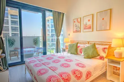 a bedroom with a bed and a large window at Studio Haven in Dubai