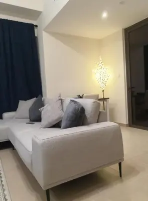 a white couch with pillows in a living room at New Horizon 2 Bedroom LUXURY APARTMENT JBR MARINA in Dubai