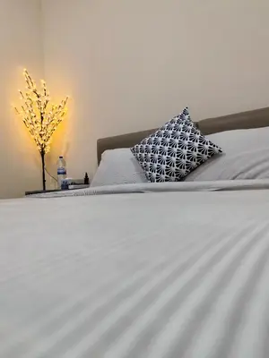 a bed with two pillows and a plant on it at New Horizon 2 Bedroom LUXURY APARTMENT JBR MARINA in Dubai