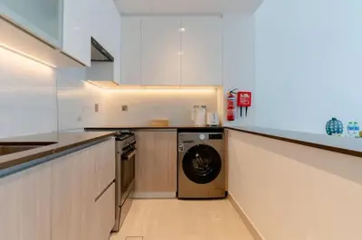 a kitchen with a washer and a dishwasher at New building l Near Metro l Spacious lay out in Dubai