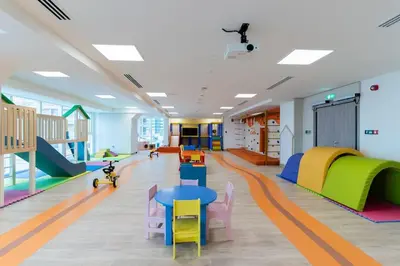 a classroom with colorful tables and ramps in a room at New building l Near Metro l Spacious lay out in Dubai