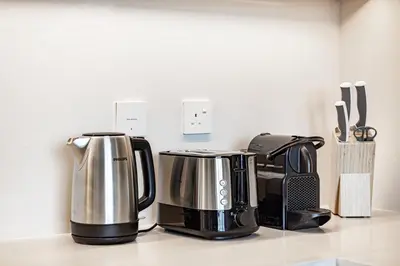 two coffee makers sitting on a counter in a kitchen at Daniels 1BR at Creek Edge with Waterfront View in Dubai