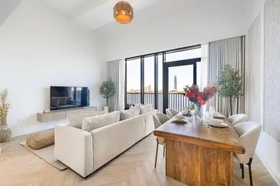 a living room with a couch and a table at Daniels 1BR at Creek Edge with Waterfront View in Dubai