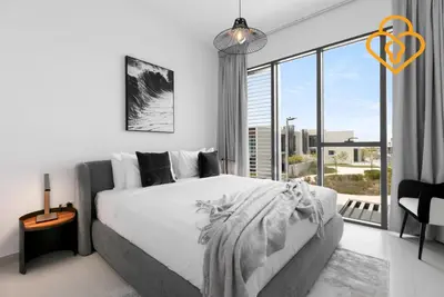 a bedroom with a large bed and a large window at Keysplease 4BR Villa walking to pool, Cherrywoods Family Community in Dubai