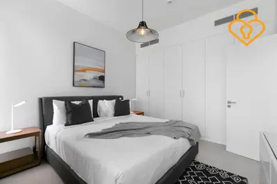 a white bedroom with a bed and a pendant light at Keysplease 4BR Villa walking to pool, Cherrywoods Family Community in Dubai