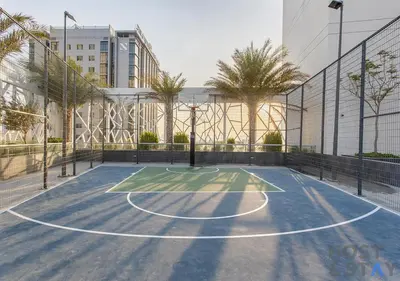 a tennis court in a city with palm trees at Elegant 1BR Getaway in Bella Rose, Al Barsha in Dubai