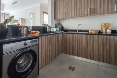 a kitchen with a washing machine in a kitchen at Frank Porter - Dunya Tower in Dubai
