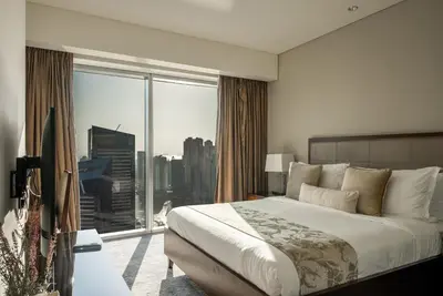 a bedroom with a large bed and a large window at Apartments in Address Dubai Marina Residences connected to Marina Mall in Dubai