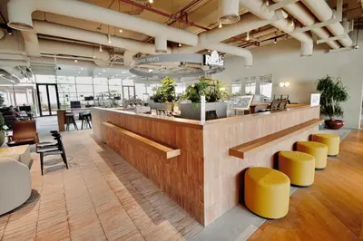 a lobby with a bar with yellow stools at Business-Ready Executive Studio with Burj View in Dubai