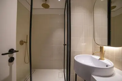 a bathroom with a sink and a shower at Business-Ready Executive Studio with Burj View in Dubai